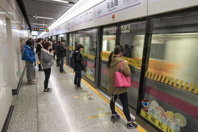 People waiting on platform at subway station