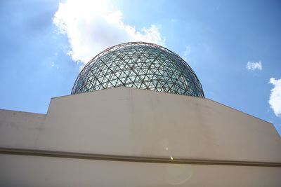 Low angle view of building against cloudy sky