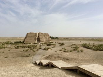 Anciente building on landscape against sky