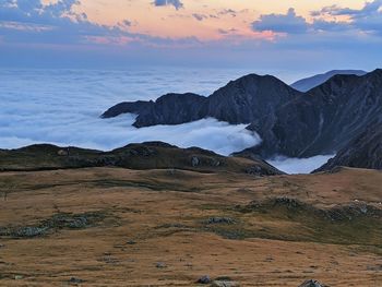 Scenic view of snowcapped mountains against sky during sunset