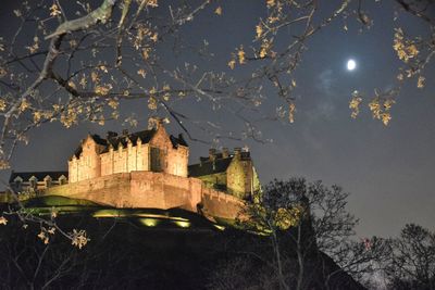 Low angle view of historic building against sky at night