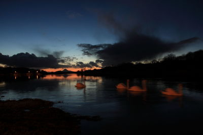 Scenic view of lake against sky at night