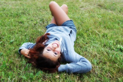 Young woman lying on field