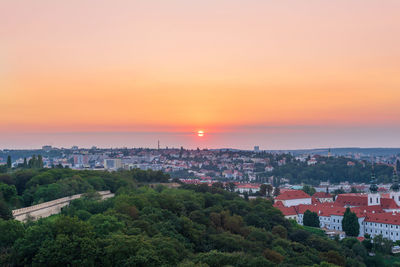 High angle view of townscape against orange sky