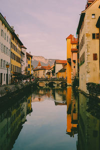 Reflection of buildings in city against sky