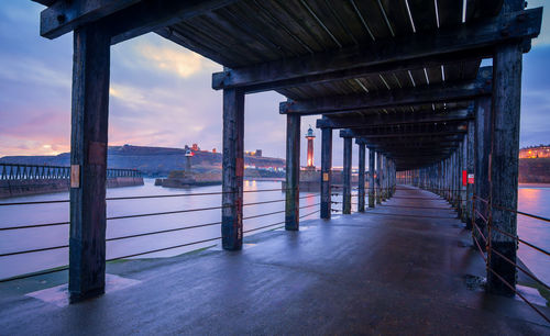 Bridge over sea at sunset