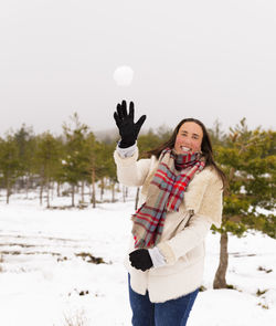 Portrait of smiling woman on snow