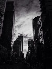 Low angle view of modern building against cloudy sky