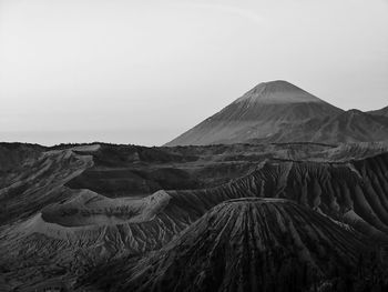 Panoramic view of arid landscape against clear sky