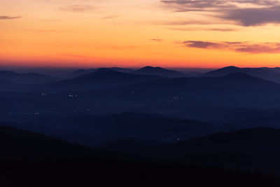 Scenic view of silhouette mountains against sky during sunset