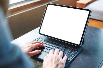 Midsection of woman using laptop