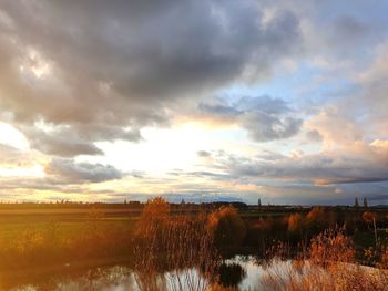 Scenic view of field against sky during sunset