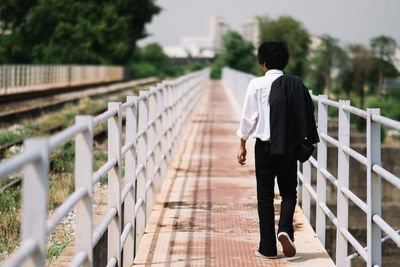 Businessman walking on footbridge