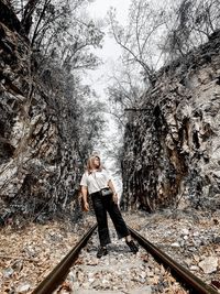 Woman standing on railroad track