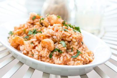 Close-up of prawns rice in plate on table