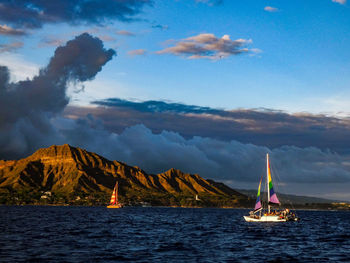 Sailboat sailing on sea against sky