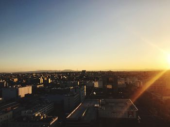 High angle view of illuminated cityscape against sky during sunset