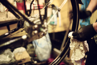 Close-up of man working on bicycle