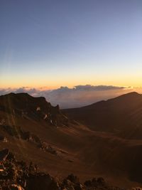 Scenic view of desert against clear sky during sunset