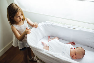 High angle view of mother and daughter in bathtub at home