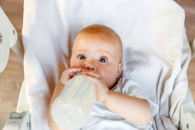 Portrait of cute baby girl drinking milk