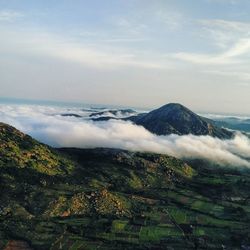 Scenic view of mountains against cloudy sky