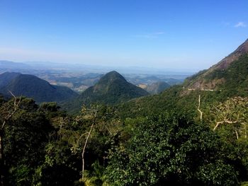 Scenic view of mountains against blue sky