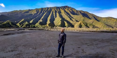 Man standing on mountain against sky