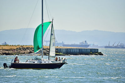 Boat sailing in sea against sky