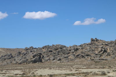 Scenic view of rocky mountains against blue sky