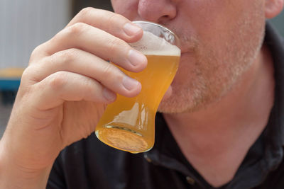Close-up of man holding drink