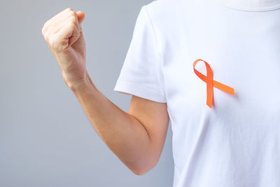 Low section of man standing against white background