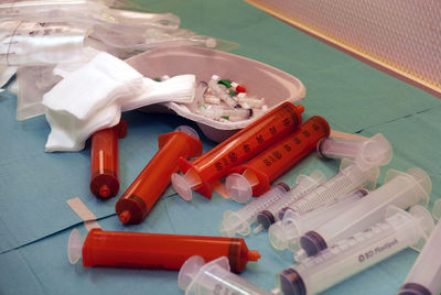 High angle view of syringes on table