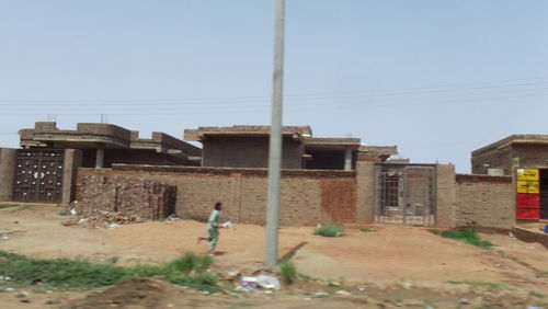 Side view of man walking on footpath