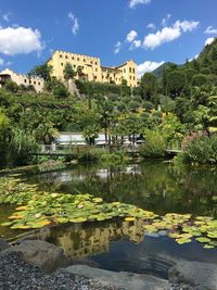 Lake and buildings against sky