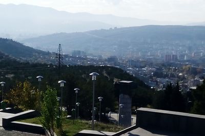 High angle view of trees and buildings in city