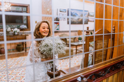 Portrait of smiling young woman standing in city