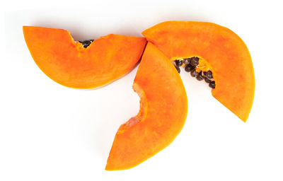 Close-up of orange fruit against white background