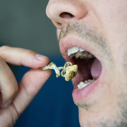 Close-up of man eating food