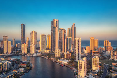 Modern buildings in city against clear sky