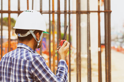 Rear view of man working at construction site