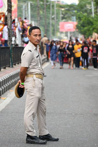 Side view of man standing on road