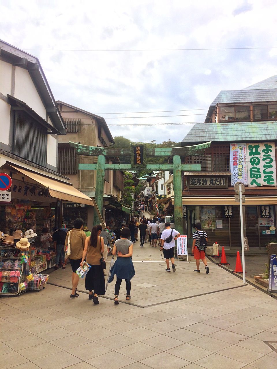 architecture, large group of people, building exterior, built structure, person, men, lifestyles, street, leisure activity, walking, sky, city, the way forward, street market, casual clothing, retail, cloud - sky, buying, outdoors, city life, day, street scene