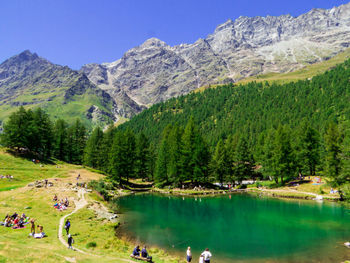 Scenic view of lake and mountains against sky