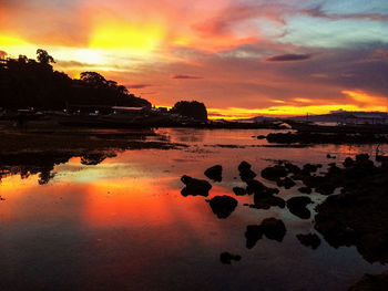 Scenic view of dramatic sky over sea during sunset