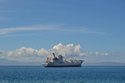 Ship sailing in sea against sky