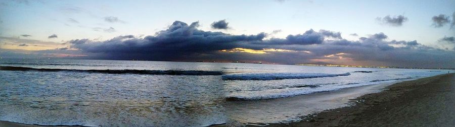 Scenic view of beach against sky during sunset