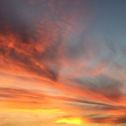 Low angle view of cloudy sky at sunset