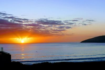 Scenic view of sea against romantic sky at sunset