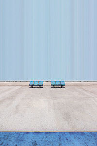 Shades of blue. minimalistic shot of empty benches at a basketball court.